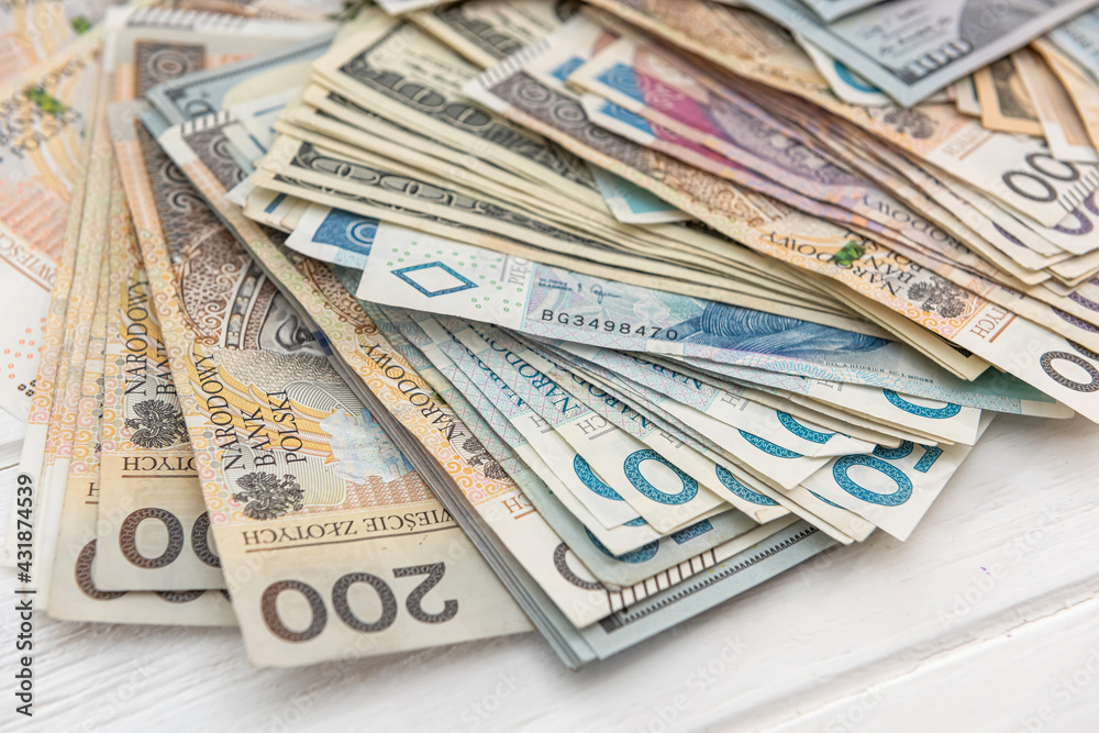 pile of us dollar and polish zloty banknotes as background pile of us dollar and polish zloty banknotes as background