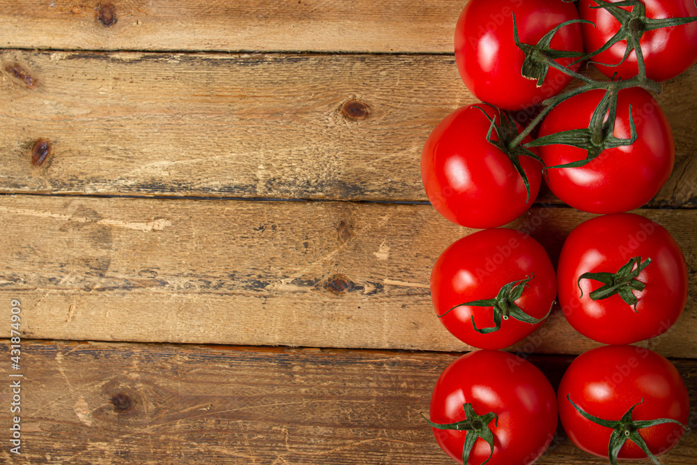 Tomatoes on a wooden background. Ripe and fresh tomatoes. Healthy vegetables. There is a place for an inscription or logo Tomatoes on a wooden background. Ripe and fresh tomatoes. Healthy vegetables. There is a place for an inscription or logo