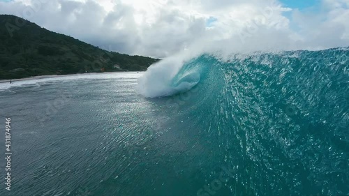 Ocean wave breaks on the shore. Atlantic Ocean wave barrels and breaks at Matadeiro beach on Santa Catarina island in Brazil photo