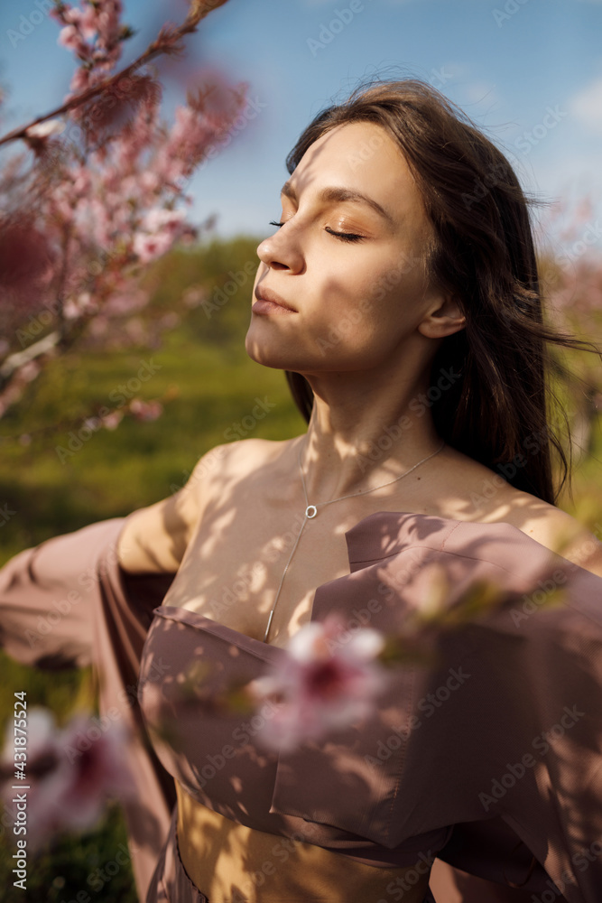 beautiful young woman outdoor in bloom field