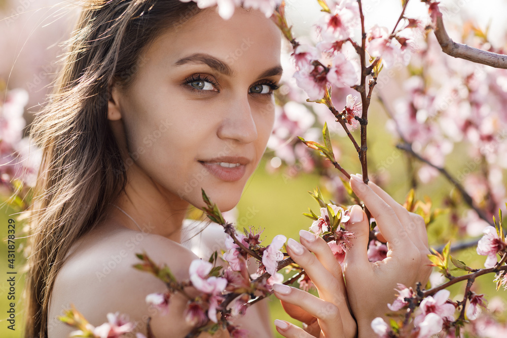 Portrait of a happy young woman in peach field