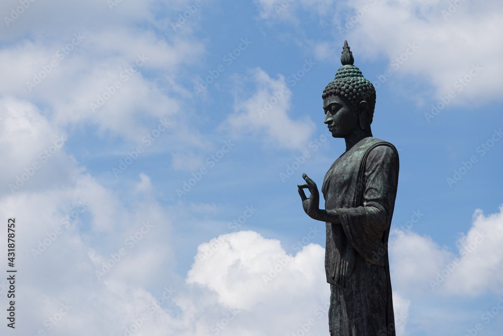 Large standing Buddha statue with cloud in the background. Large standing Buddha statue with cloud in the background.