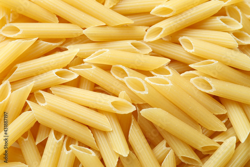 Uncooked pasta on whole background, close up