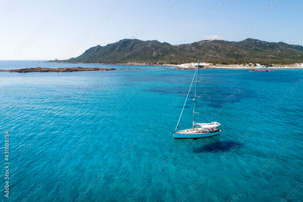 ITALY - Sardinia - Sailboat at anchor at the Capo Comino beach on the east coast of Sardinia ITALY - Sardinia - Sailboat at anchor at the Capo Comino beach on the east coast of Sardinia