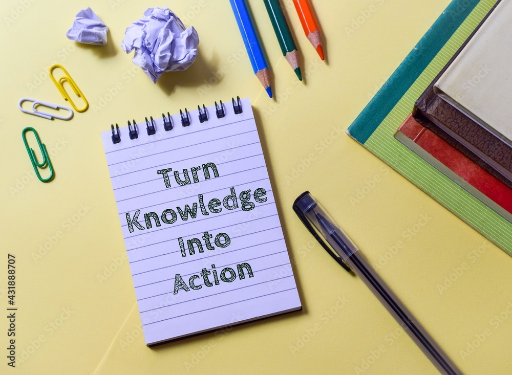 Turn Knowledge Into Action motivational message in a notepad placed on yellow background with stationery supplies. Turn Knowledge Into Action motivational message in a notepad placed on yellow background with stationery supplies.