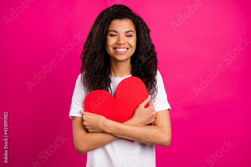 Photo of sweet brunette young lady hug heart wear white t-shirt isolated on pink color background