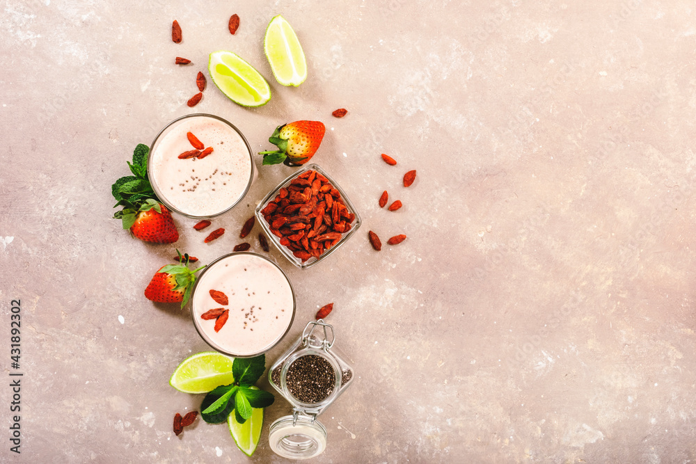 Healthy blended diet smoothie drink with strawberry and goji berries, chia seeds and lime. Top view - obrazy, fototapety, plakaty 