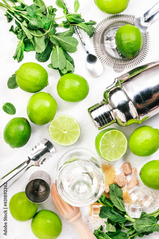 Mojito cocktail preparing ingredients: lime, mint, ice and bar tools, white background, top view - obrazy, fototapety, plakaty 