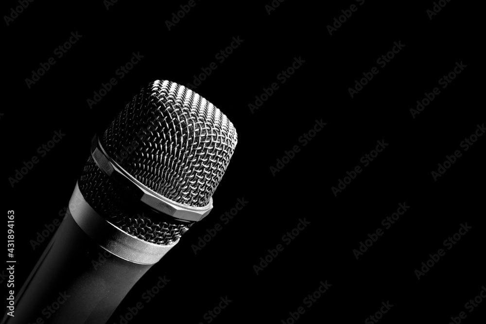 a man holding a microphone on a black background a man holding a microphone on a black background