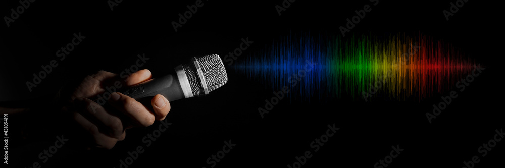 a man holding a microphone on a black background
