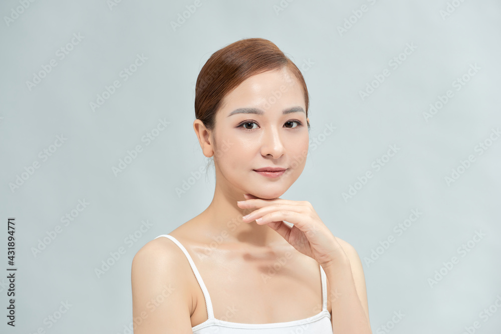 Happy beautiful asian girl with the fresh skin in white background. Expressive facial expressions. Cosmetology and Spa concept. Happy beautiful asian girl with the fresh skin in white background. Expressive facial expressions. Cosmetology and Spa concept.