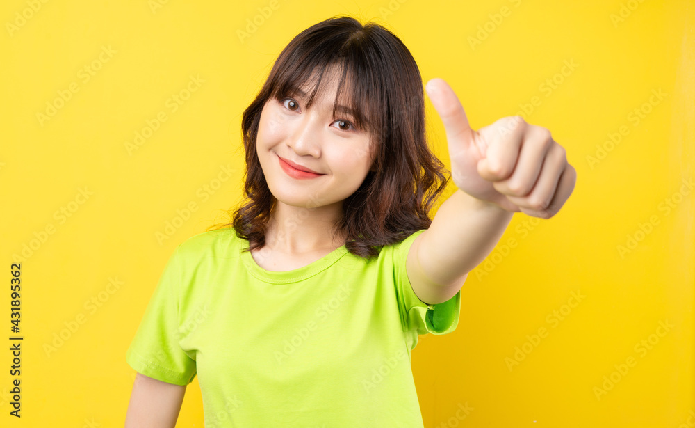 Young Asian girl with expressions and gestures on background Young Asian girl with expressions and gestures on background