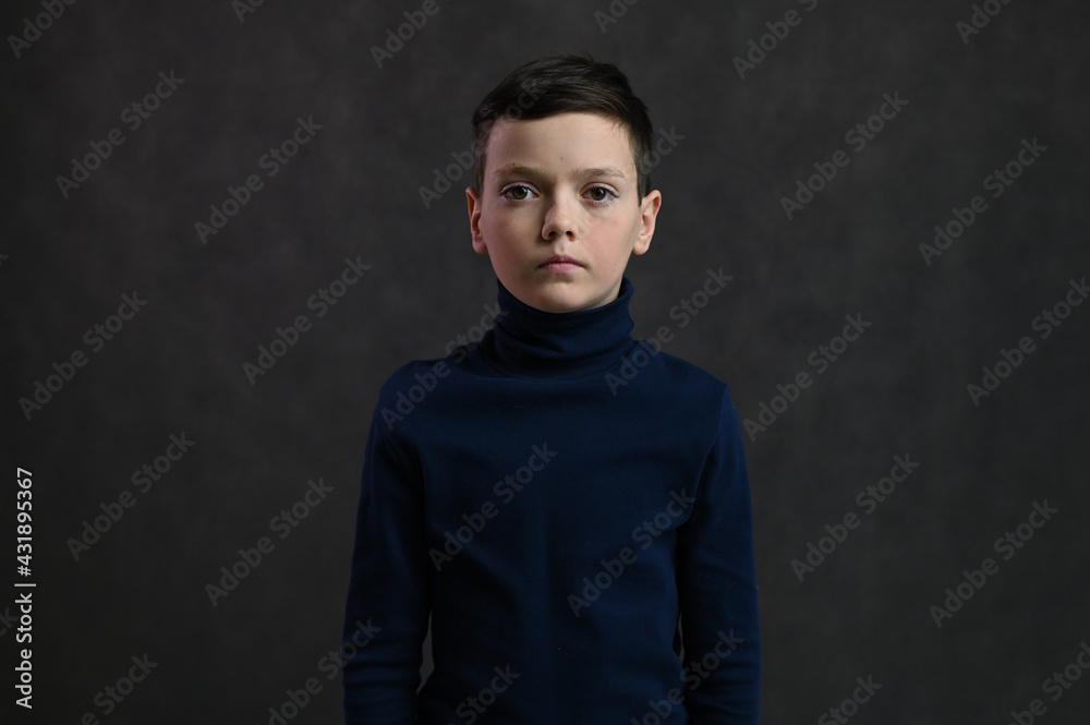 Studio photo portrait of serious teenager guy on gray background Studio photo portrait of serious teenager guy on gray background