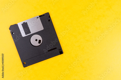 Floppy disk isolated on yellow background. Retro computer diskette