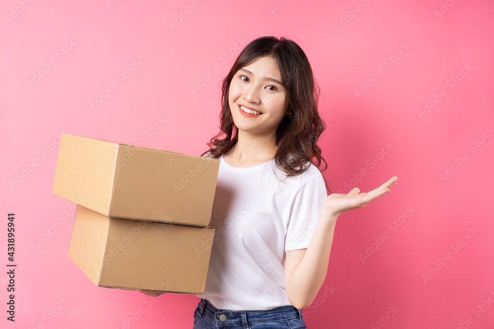 Woman holding the cargo box and smiling happily Woman holding the cargo box and smiling happily