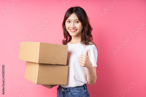 Woman holding the cargo box and smiling happily