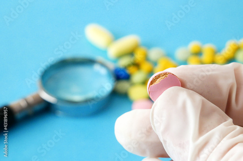 bad medicine takes in hand closeup, expired fake pills concept photo