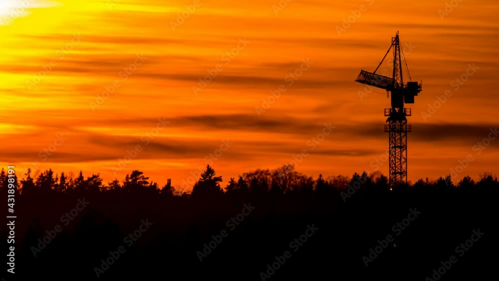 Amazing sunset time-lapse video with industrial cityscape. The tower cranes in the foreground. Amazing sunset time-lapse video with industrial cityscape. The tower cranes in the foreground.