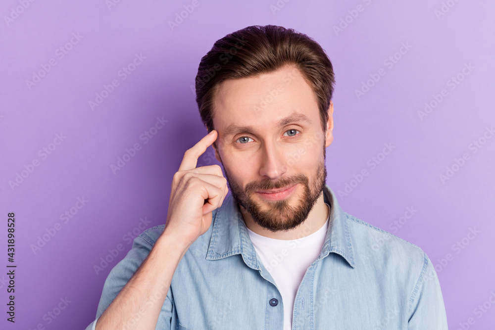 Photo of confident smart young gentleman dressed jeans outfit finger forehead smiling isolated violet color background Photo of confident smart young gentleman dressed jeans outfit finger forehead smiling isolated violet color background
