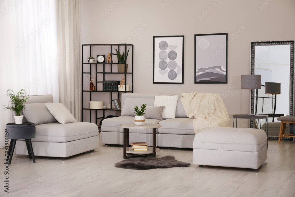 Stylish living room interior with comfortable sofa and large mirror Stylish living room interior with comfortable sofa and large mirror