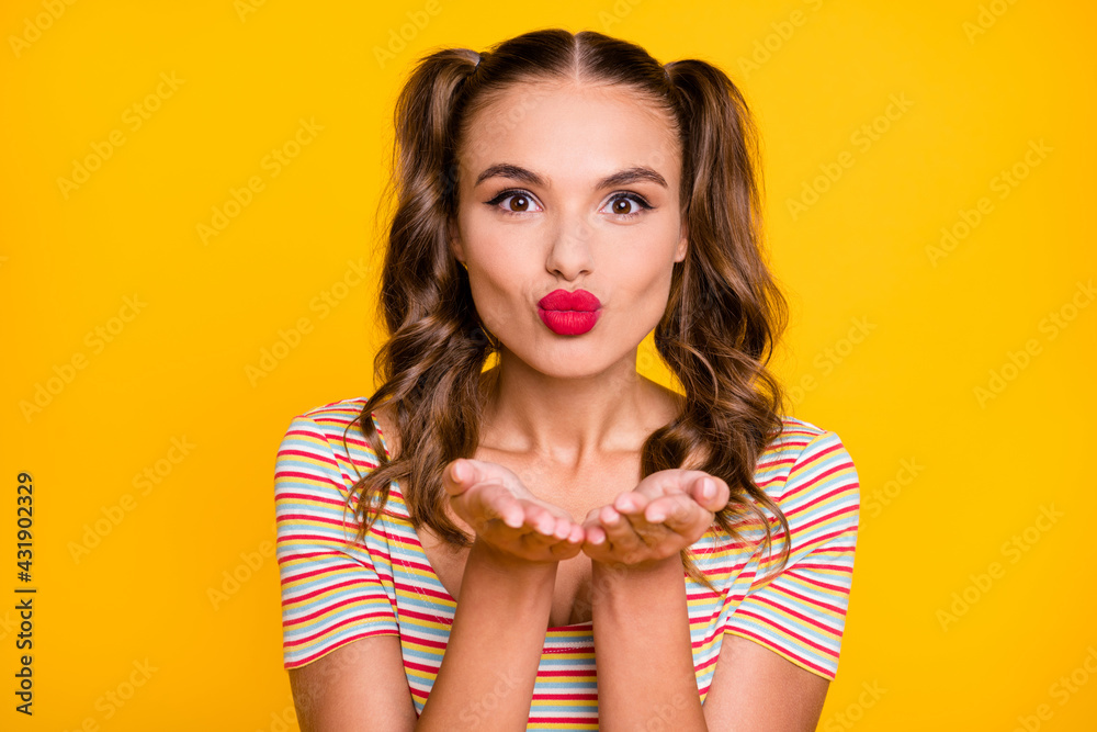 Portrait of young attractive lovely pretty cute sweet nice girl send air kiss in camera isolated on yellow color background Portrait of young attractive lovely pretty cute sweet nice girl send air kiss in camera isolated on yellow color background