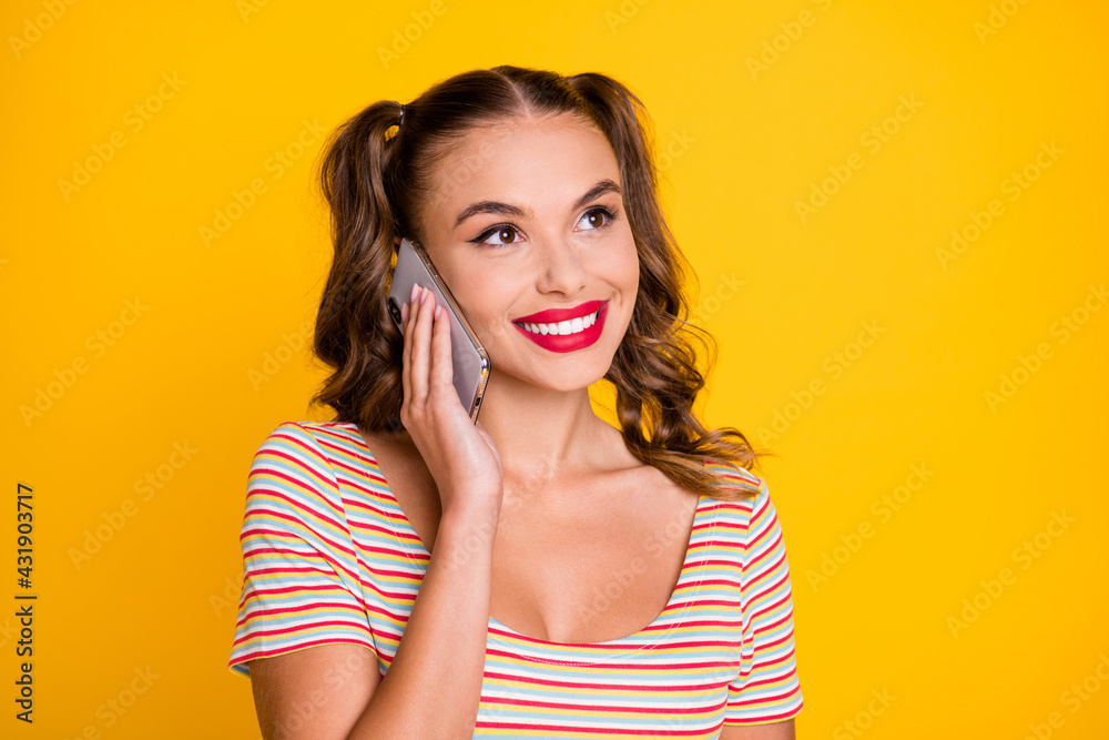 Photo of young attractive lovely pretty smiling cheerful happy girl talking on phone isolated on yellow color background Photo of young attractive lovely pretty smiling cheerful happy girl talking on phone isolated on yellow color background