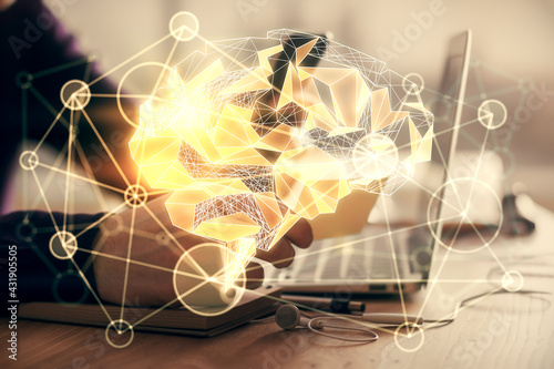 Double exposure of man's hand holding and using a digital device and brain hologram drawing. Data concept.
