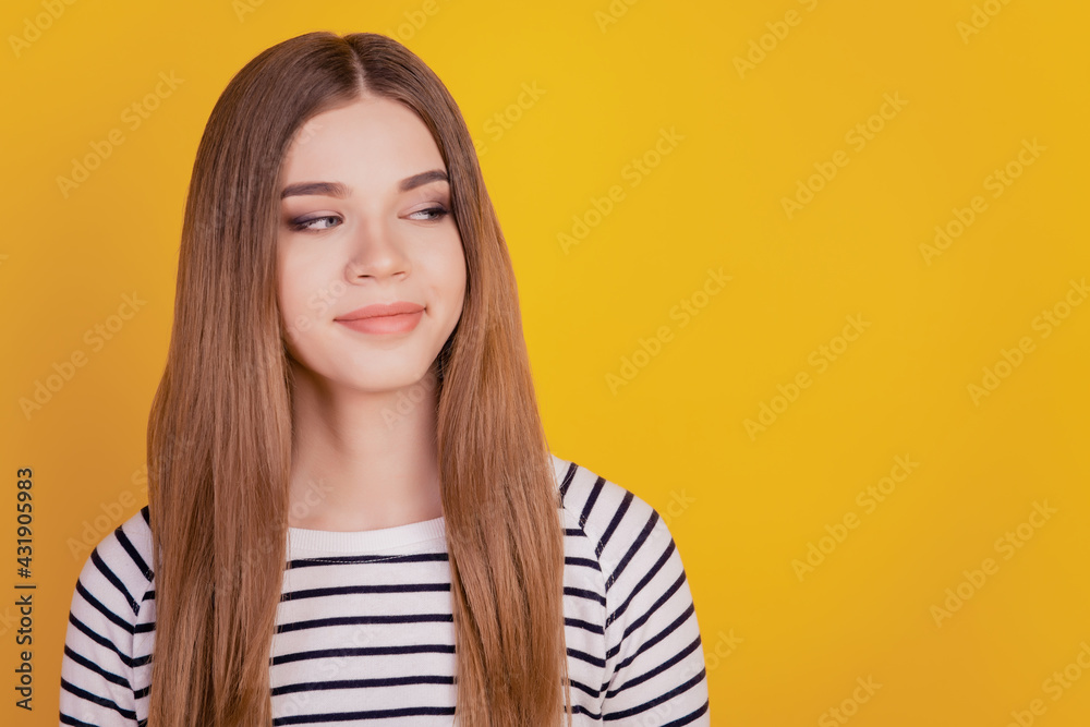Portrait of positive lady look side empty space smile on yellow background Portrait of positive lady look side empty space smile on yellow background