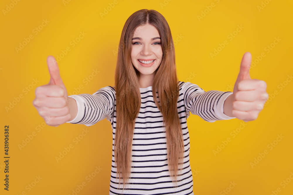 Portrait of promoter woman raise thumb up look camera on yellow wall recommendation concept Portrait of promoter woman raise thumb up look camera on yellow wall recommendation concept