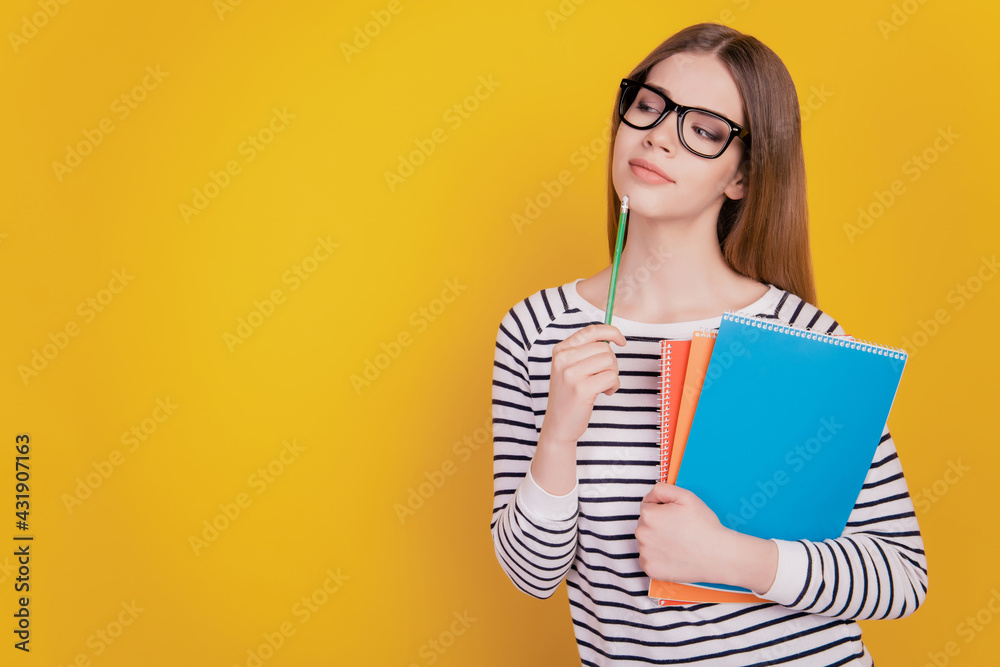 Photo of schoolgirl with copybooks education concept on yellow background Photo of schoolgirl with copybooks education concept on yellow background