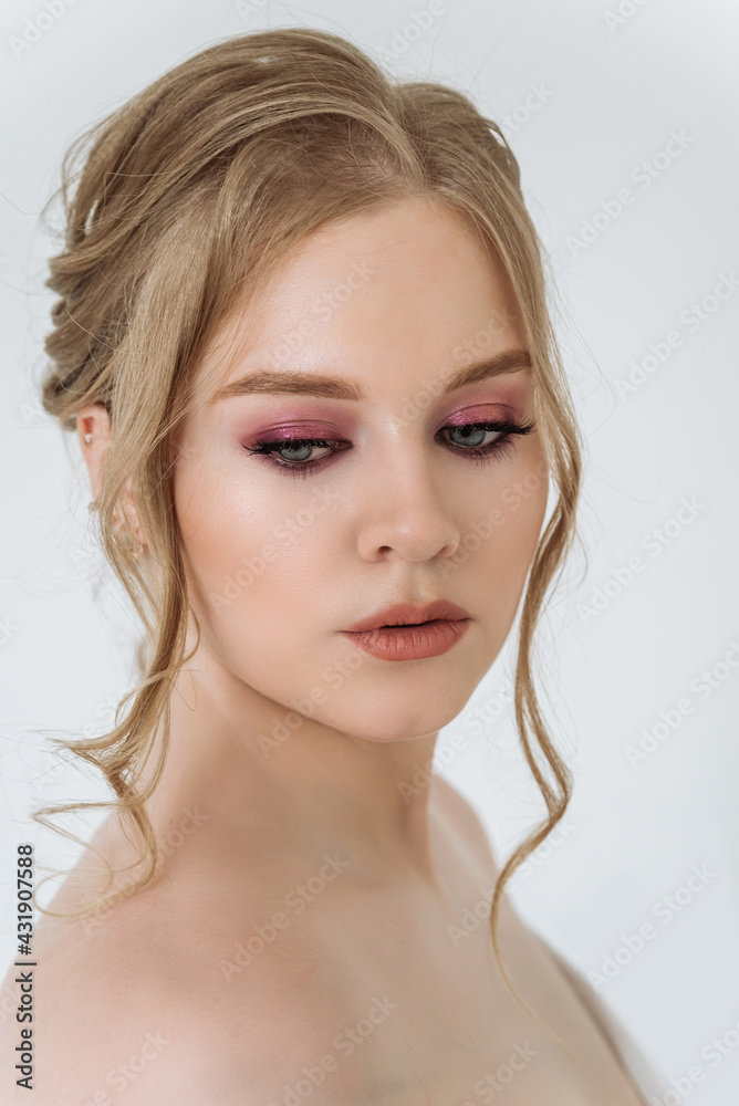 Naklejka premium portrait of a beautiful Caucasian woman with light skin and blonde hair with blue eyes close-up on a white background. attractive young woman with beautiful makeup. skin care, beauty concept