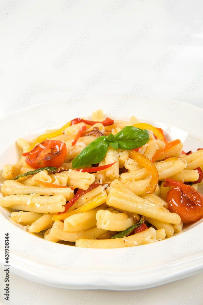 vegan pasta called casarecce con le verdure and chili evo oil or pasta whit fresh vegetables zucchini yellow pepper cherry tomatoes and chili extra virgin oil from Calabria vegan pasta called casarecce con le verdure and chili evo oil or pasta whit fresh vegetables zucchini yellow pepper cherry tomatoes and chili extra virgin oil from Calabria