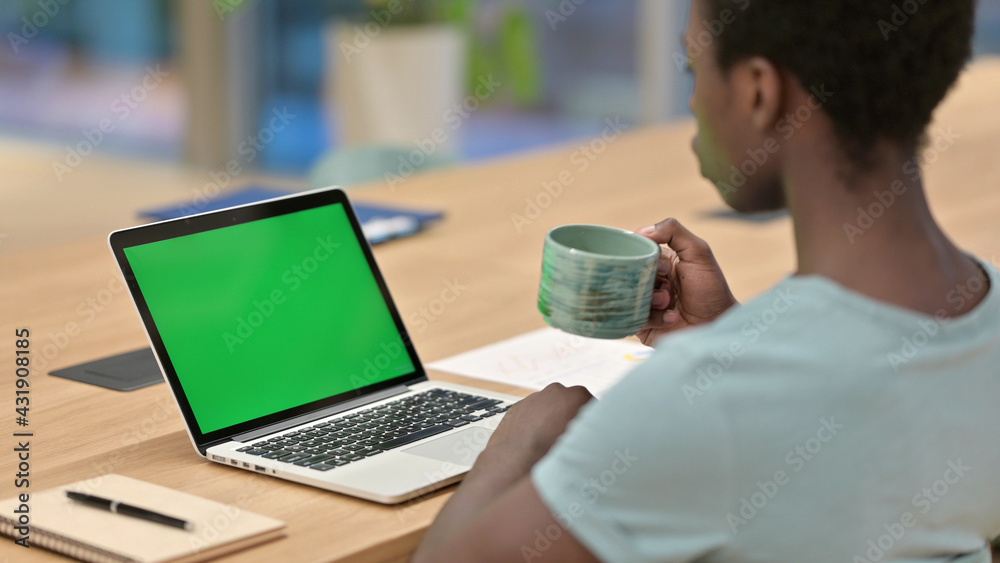 African Man Drinking Coffee while Using Laptop with Chroma Screen African Man Drinking Coffee while Using Laptop with Chroma Screen