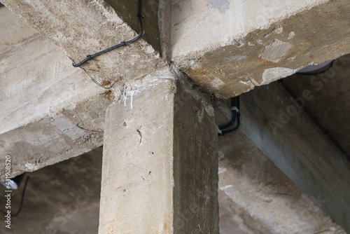 A concrete pillar that support the beams of the house.