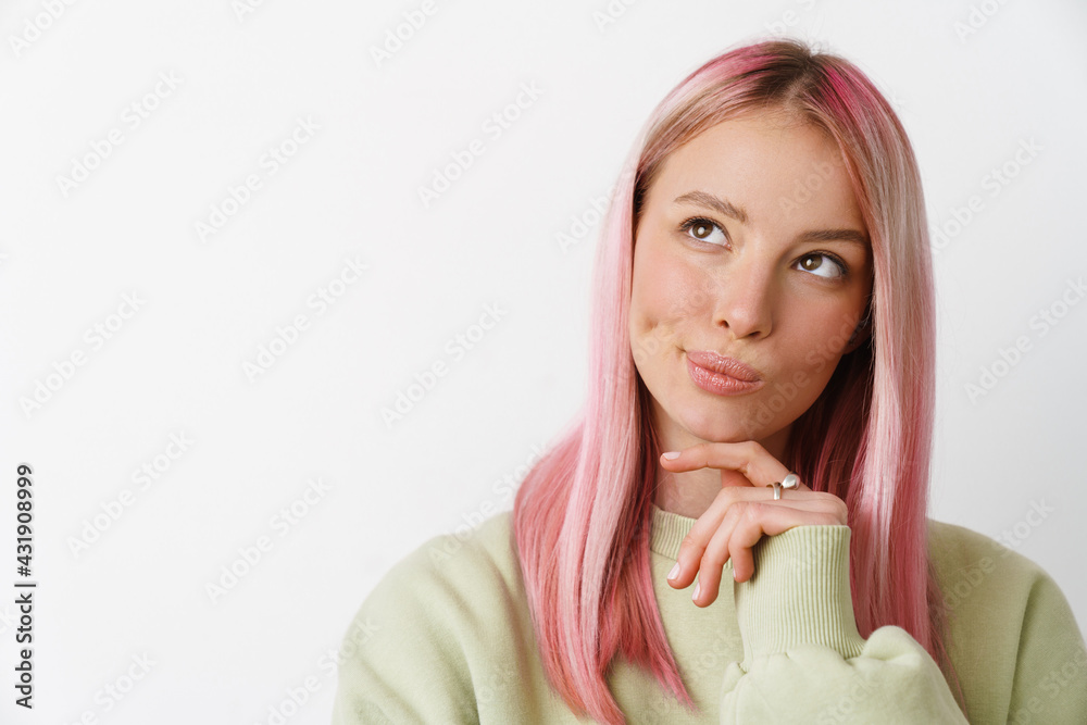 Young white thinking woman with pink hair looking upward Young white thinking woman with pink hair looking upward