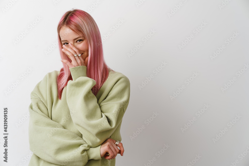 Young white woman with pink hair smiling and covering her face Young white woman with pink hair smiling and covering her face