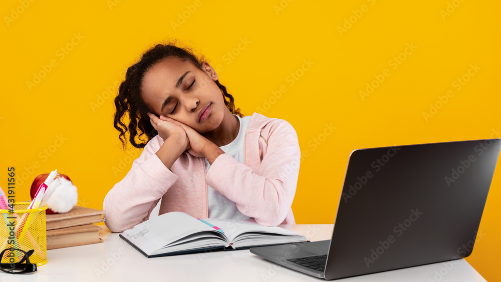 Tired black girl sitting at desk and sleeping Tired black girl sitting at desk and sleeping