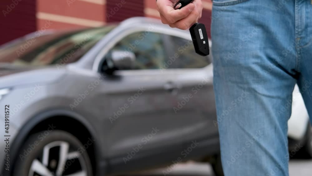 The man pulls out the car keys from his pocket. Car purchase, rental, insurance, car safety. The man pulls out the car keys from his pocket. Car purchase, rental, insurance, car safety.