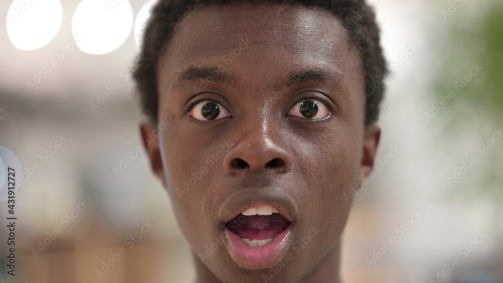 Close up of Shocked Young African Man Face, Wondering Close up of Shocked Young African Man Face, Wondering