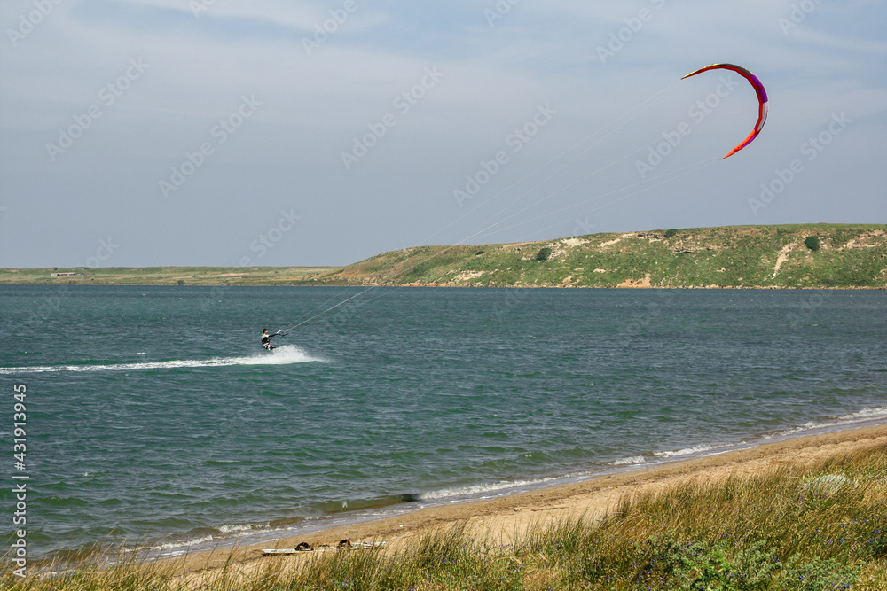 Man kite surfing (kite-boarding) in the Salt lake (Tuz golu) near Kefalos beach in Gokceada island (Imbros), Canakkale, Turkey