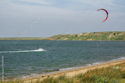 Man kite surfing (kite-boarding) in the Salt lake (Tuz golu) near Kefalos beach in Gokceada island (Imbros), Canakkale, Turkey