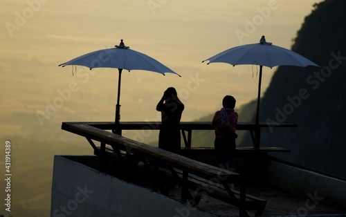 silhouette of a couple on the mountain during sunrise. 