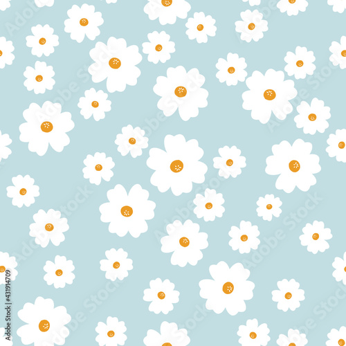 Seamless pattern with chamomiles on blue background vector illustration. Cute floral print.