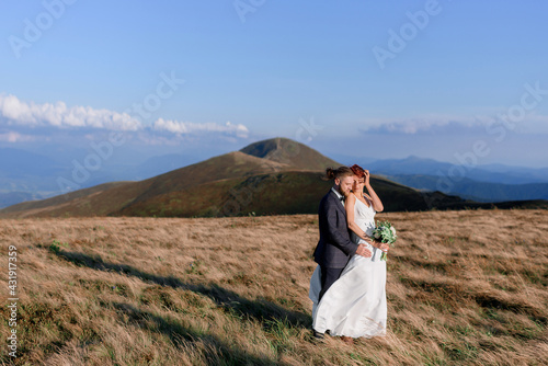 Side view of love story of a beautiful couple outdoors on a sunny day. Concept of outdoor love story