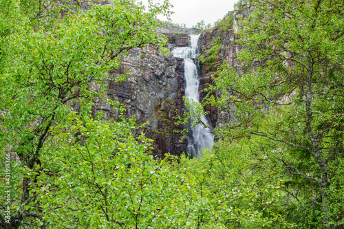 Waterfall in a birch forest on a mountain