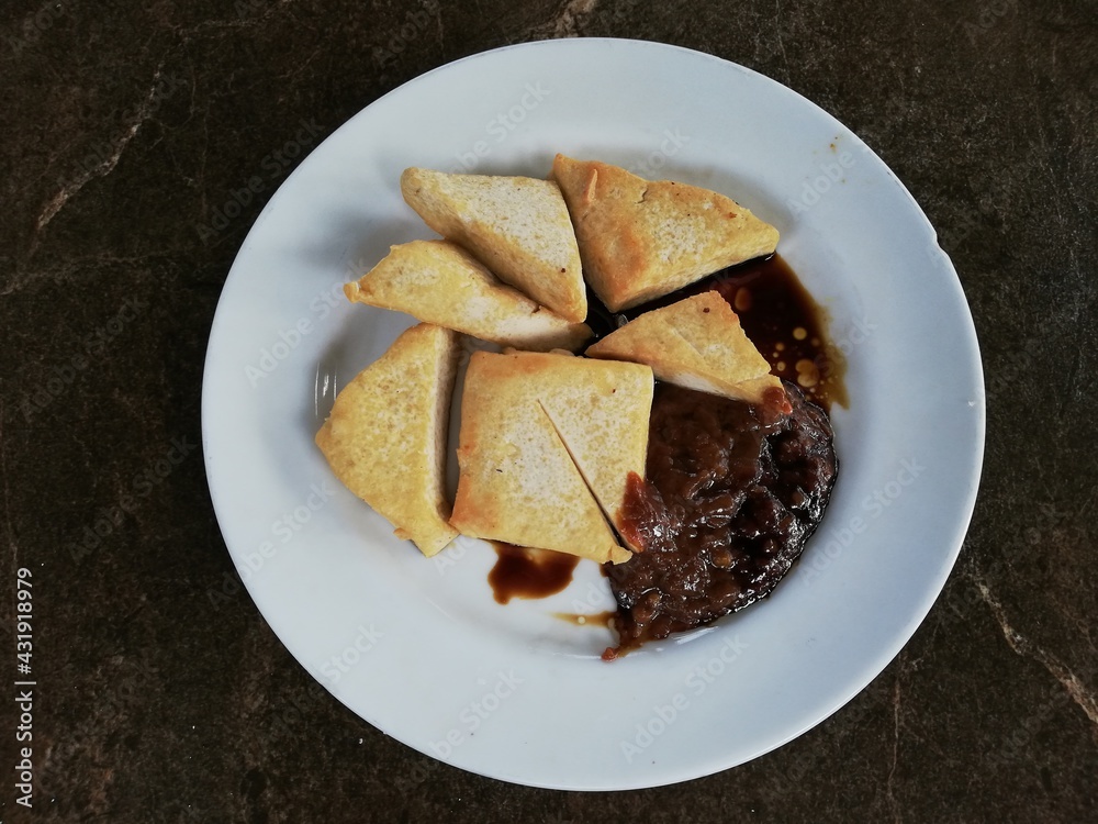 Fried tofu with chili sauce on a plate Fried tofu with chili sauce on a plate