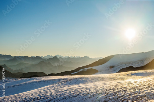 Mt. Elbrus glacier fields against Caucasus mountains in the evening before sunset. Panoramic view from 