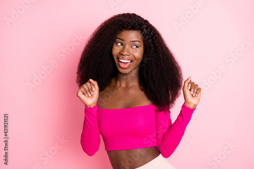 Photo of carefree funny lady look empty space dance wear top uncovered shoulders isolated pink color background