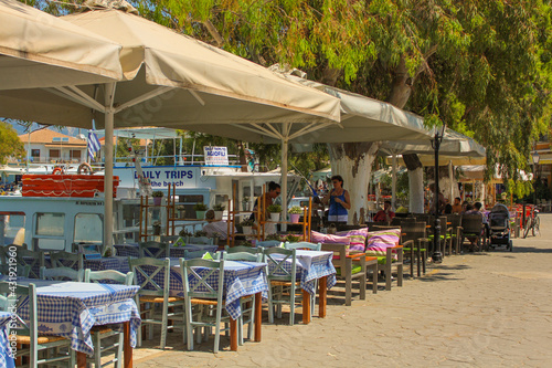 Vasiliki, Greece - July 24 2019: Architecture of Vasiliki, restaurants, oldschool cars, markets with people walking by