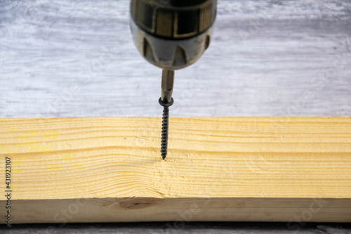 Screwing the self-tapping screw with a screwdriver.